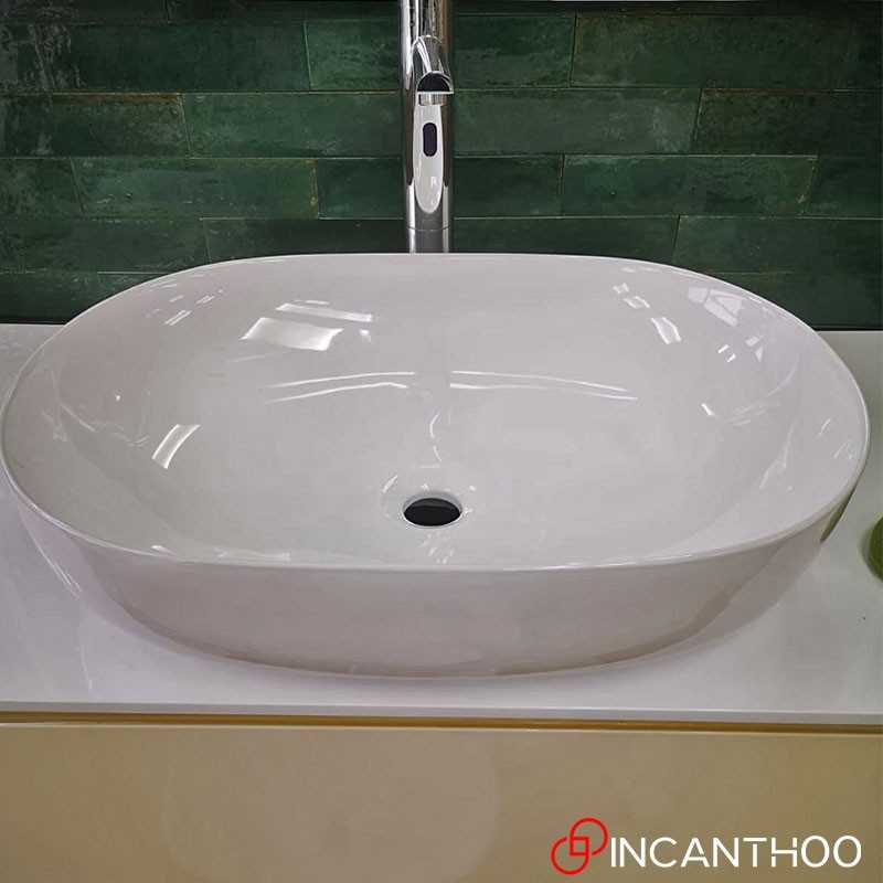 Lavabo da appoggio ovale in ceramica bianco lucido serie DRV cm 60,5x40 con  foro rubinetto